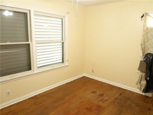 unfurnished room featuring dark hardwood / wood-style flooring