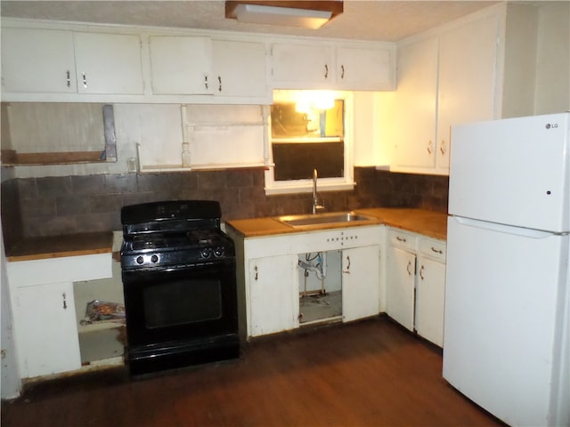 kitchen featuring white cabinetry, black range with gas cooktop, sink, and white fridge