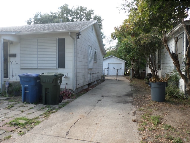 view of property exterior featuring a garage and an outdoor structure