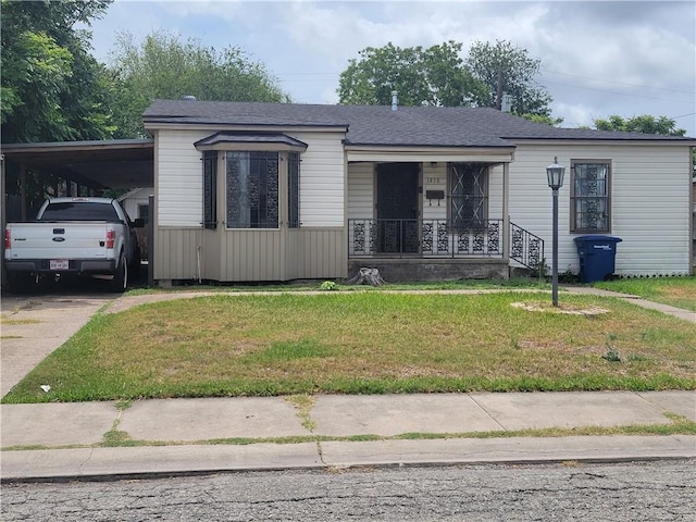 1438 Melbourne Dr, Corpus Christi, TX 78415 - view of front of property with covered porch, a front yard, concrete driveway, and an attached carport