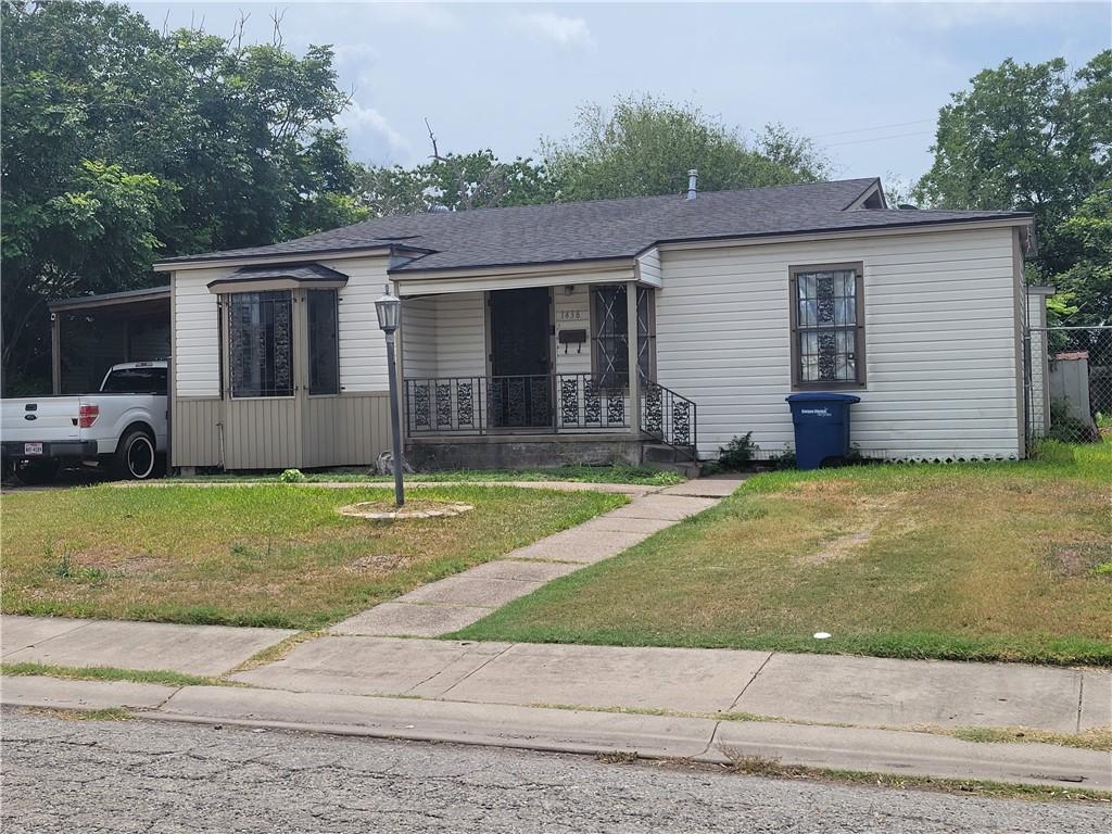 1438 Melbourne Dr, Corpus Christi, TX 78415 - view of front of house with a porch, a front lawn, and roof with shingles