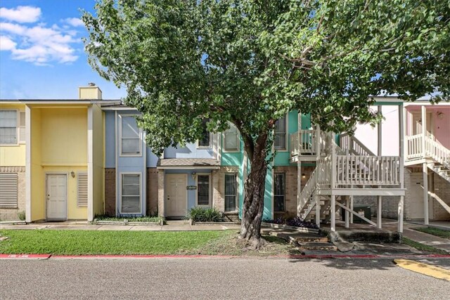 6702 Everhart Unit N102, Corpus Christi, TX 78413 - view of front of property with a chimney, stairs, and brick siding