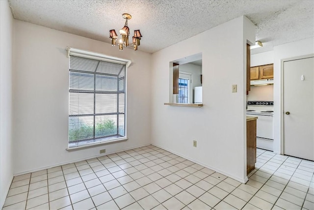 6702 Everhart Unit N102, Corpus Christi, TX 78413 - unfurnished room with a chandelier, a textured ceiling, and light tile patterned floors