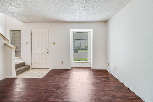 6702 Everhart Unit N102, Corpus Christi, TX 78413 - foyer featuring wood finished floors, a textured ceiling, and stairway