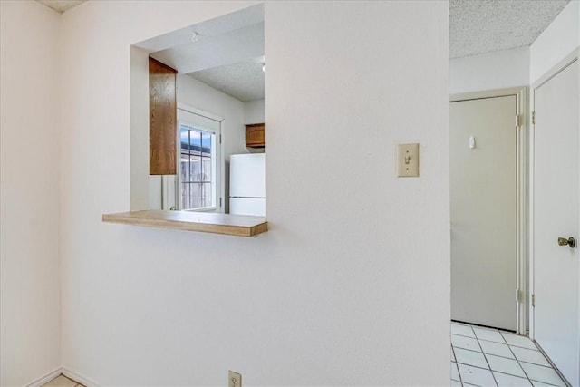 6702 Everhart Unit N102, Corpus Christi, TX 78413 - detailed view of freestanding refrigerator and a textured ceiling