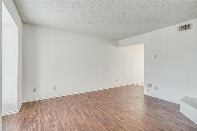 6702 Everhart Unit N102, Corpus Christi, TX 78413 - empty room with wood finished floors and a textured ceiling