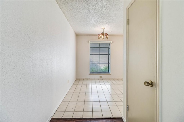 6702 Everhart Unit N102, Corpus Christi, TX 78413 - hall with a chandelier, a textured ceiling, and tile patterned floors