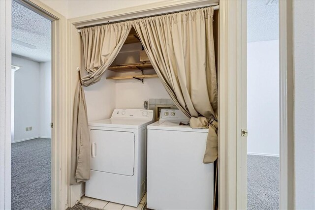 6702 Everhart Unit N102, Corpus Christi, TX 78413 - laundry room with washer and dryer, a textured ceiling, and light colored carpet