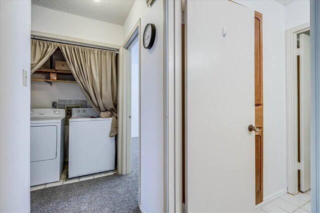 6702 Everhart Unit N102, Corpus Christi, TX 78413 - laundry room featuring washing machine and dryer and a textured ceiling