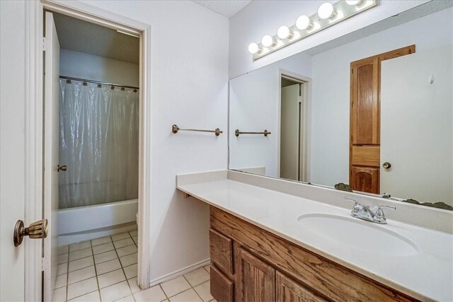 6702 Everhart Unit N102, Corpus Christi, TX 78413 - bathroom featuring vanity, tile patterned flooring, and shower / bathtub combination with curtain