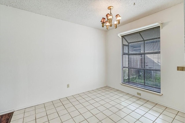 6702 Everhart Unit N102, Corpus Christi, TX 78413 - spare room with a chandelier and a textured ceiling