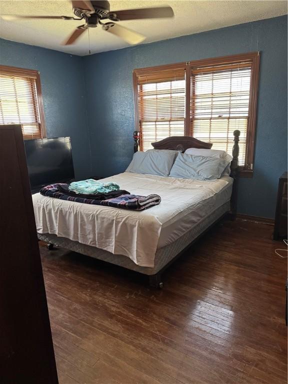 208 W Plasuela St, Refugio, TX 78377 - bedroom featuring ceiling fan and dark hardwood / wood-style floors