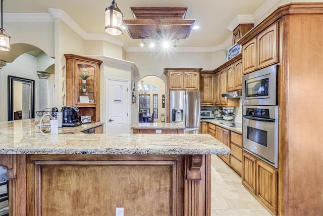4530 Ballad Tree Dr, Corpus Christi, TX 78410 - kitchen featuring appliances with stainless steel finishes, arched walkways, a peninsula, light stone countertops, and ornamental molding