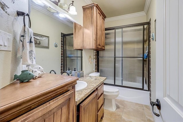 4530 Ballad Tree Dr, Corpus Christi, TX 78410 - bathroom featuring ornamental molding, vanity, toilet, enclosed tub / shower combo, and stone finish floors