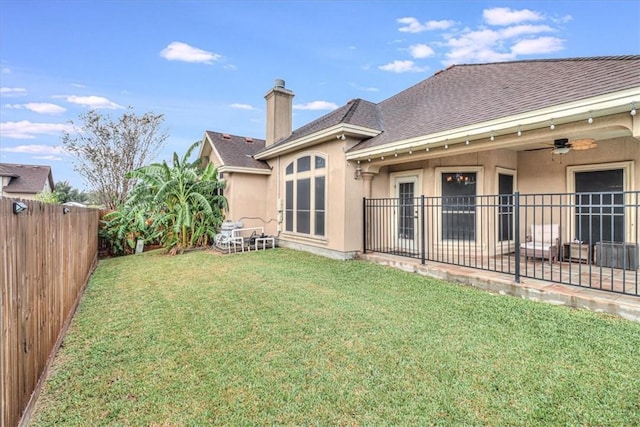 4530 Ballad Tree Dr, Corpus Christi, TX 78410 - rear view of house with stucco siding, a shingled roof, a ceiling fan, a patio area, and a chimney