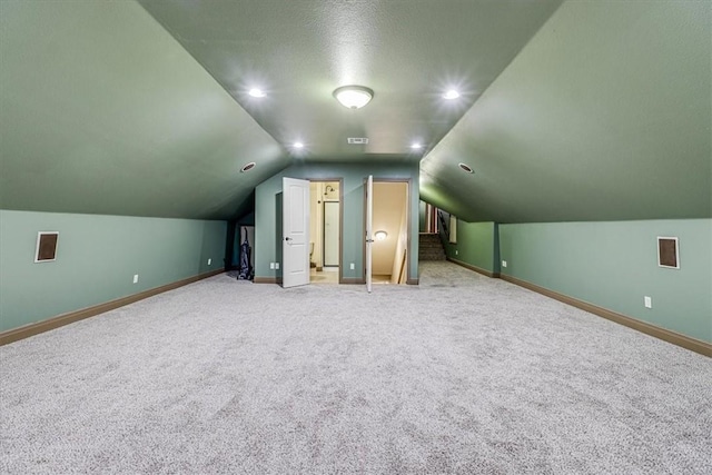 4530 Ballad Tree Dr, Corpus Christi, TX 78410 - bonus room featuring carpet floors, baseboards, vaulted ceiling, and a textured ceiling