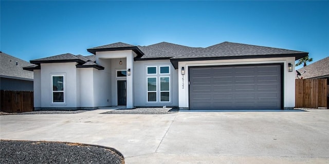15122 Aquarius St, Corpus Christi, TX 78418 - prairie-style home with concrete driveway, a garage, a shingled roof, and stucco siding