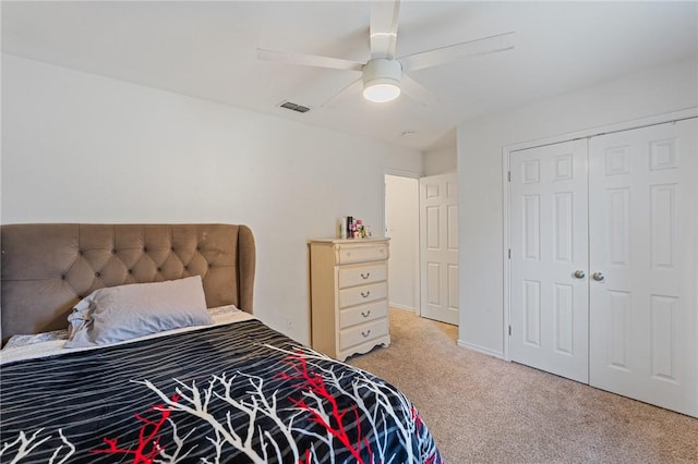 bedroom featuring light carpet, a closet, and ceiling fan