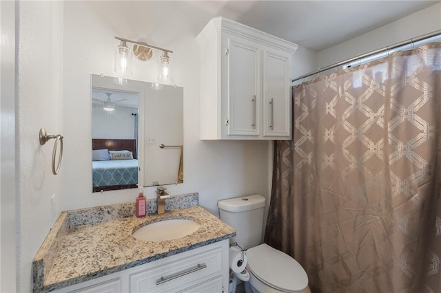 bathroom featuring vanity, curtained shower, and toilet