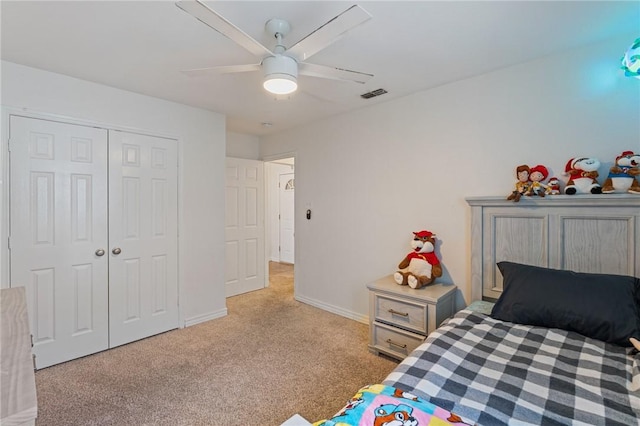 carpeted bedroom with ceiling fan and a closet