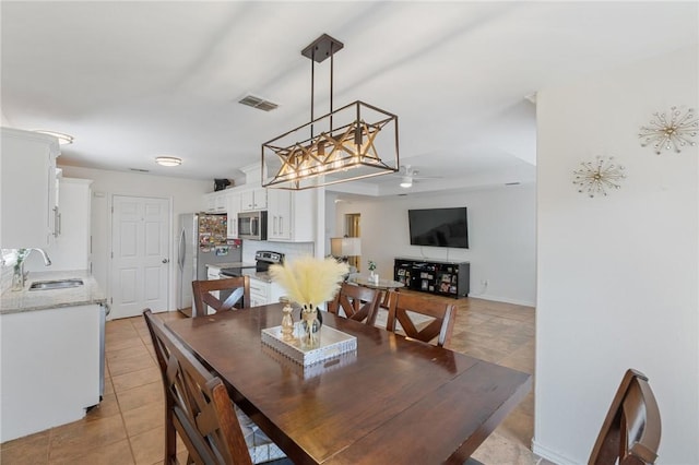 tiled dining room with sink