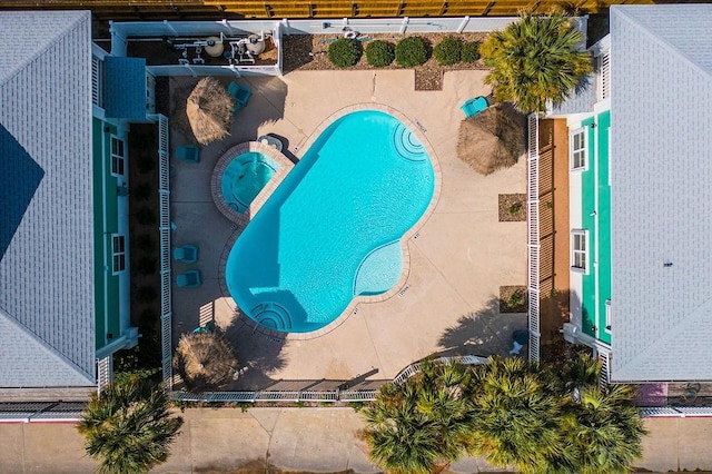 community pool featuring a community hot tub and a patio