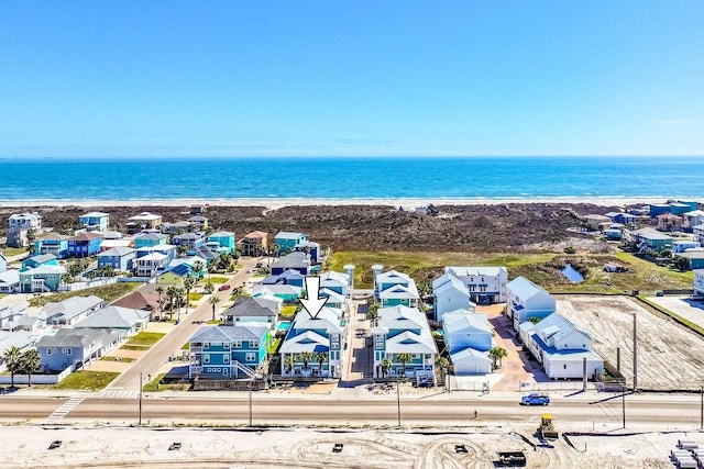 drone / aerial view with a view of the beach, a residential view, and a water view