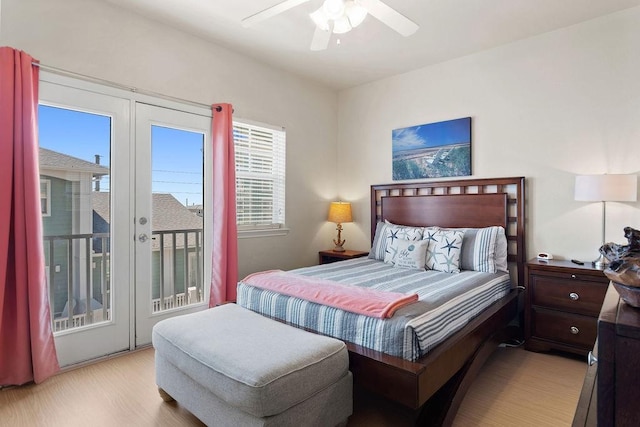 bedroom featuring access to outside, light wood finished floors, multiple windows, and a ceiling fan