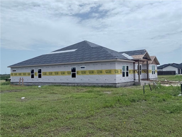 722 Mama Fefi Dr, Corpus Christi, TX 78414 - view of side of home featuring a yard and roof with shingles