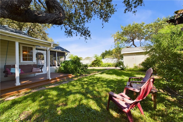 view of yard with a sunroom and a deck