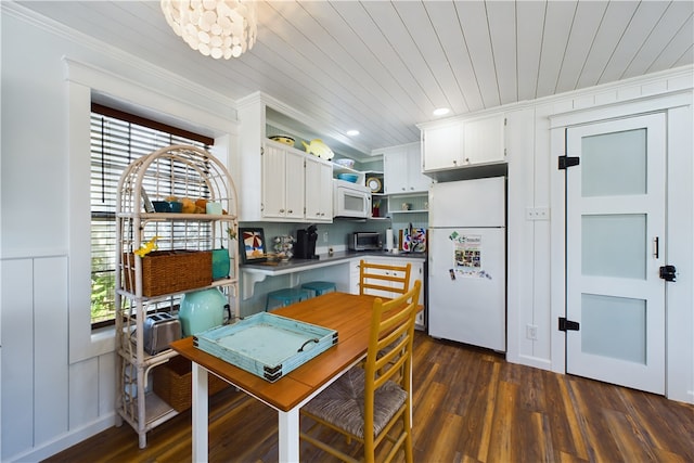 kitchen with a wealth of natural light, white cabinets, dark wood-type flooring, and white appliances