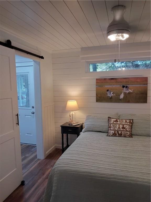 bedroom with dark hardwood / wood-style flooring