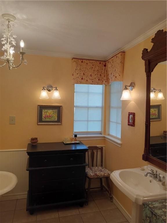 bathroom with tile patterned flooring, ornamental molding, and an inviting chandelier