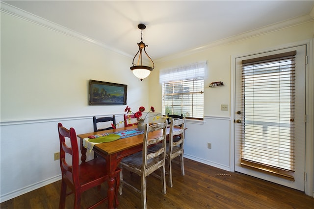 dining room with crown molding and dark hardwood / wood-style flooring