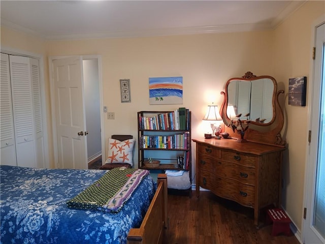 bedroom with dark hardwood / wood-style floors, crown molding, and a closet