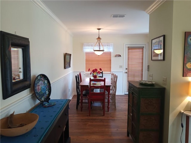 dining room featuring dark hardwood / wood-style floors and ornamental molding