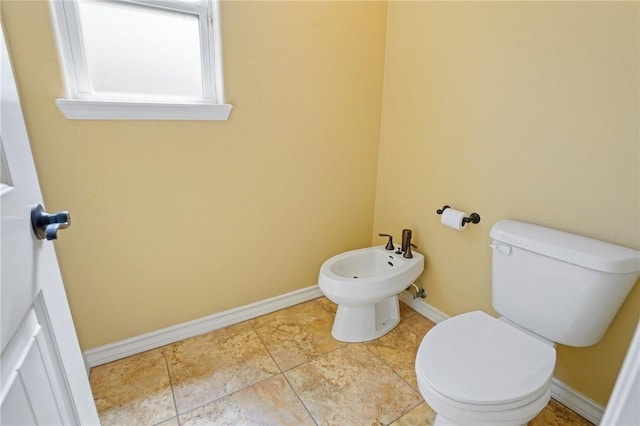 bathroom featuring a bidet and toilet