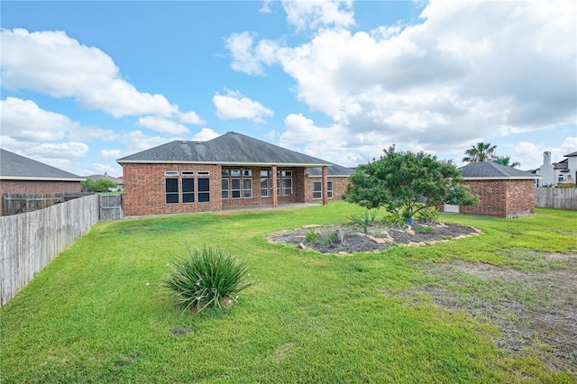 rear view of property with a yard