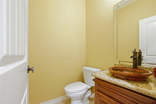 bathroom featuring toilet and vanity