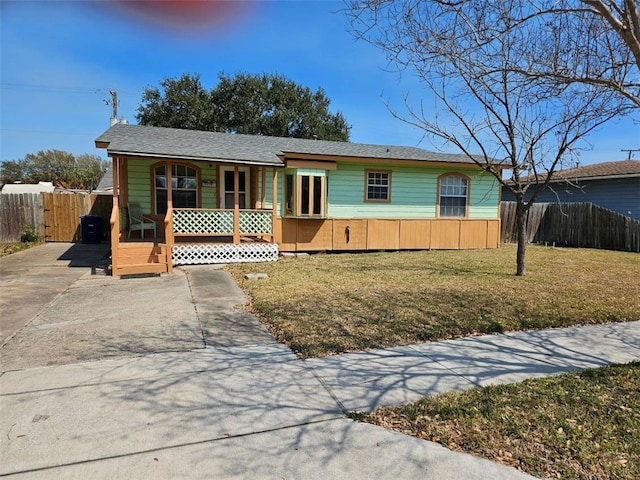 ranch-style house with a porch, driveway, a front yard, and fence