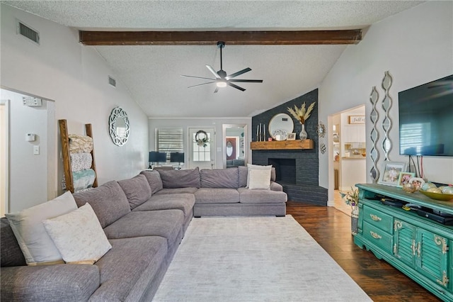 6205 Londonderry Dr, Corpus Christi, TX 78415 - living area featuring a ceiling fan, dark wood-style floors, a fireplace, and a textured ceiling