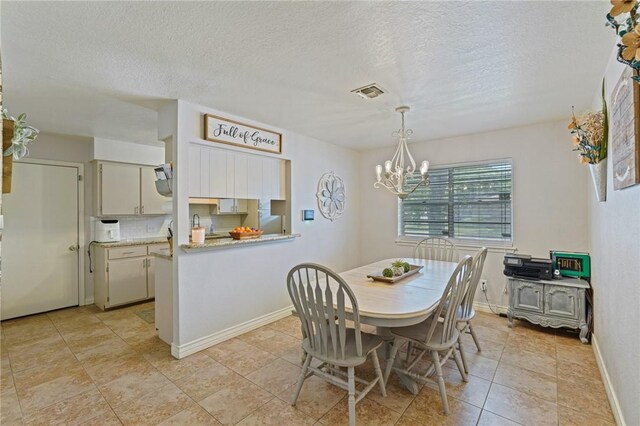 6205 Londonderry Dr, Corpus Christi, TX 78415 - dining room with a chandelier, a textured ceiling, and light tile patterned floors