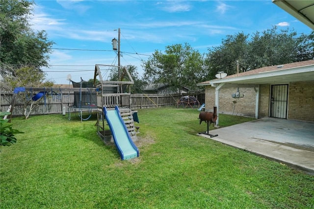 6205 Londonderry Dr, Corpus Christi, TX 78415 - fenced backyard featuring a trampoline, a playground, and a patio area