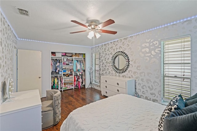 6205 Londonderry Dr, Corpus Christi, TX 78415 - bedroom featuring wallpapered walls, dark wood-type flooring, a closet, and multiple windows