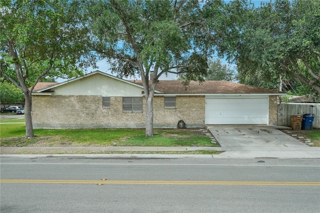 6205 Londonderry Dr, Corpus Christi, TX 78415 - view of front of house featuring brick siding, a garage, and concrete driveway