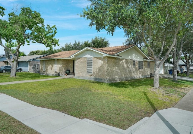 6205 Londonderry Dr, Corpus Christi, TX 78415 - view of side of home featuring a yard and brick siding