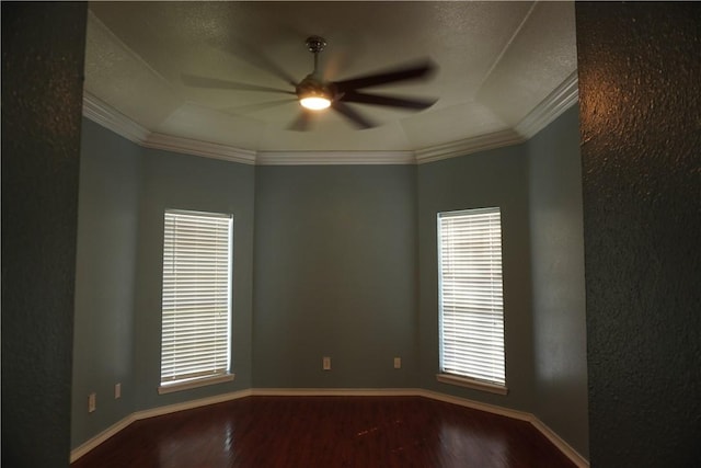 unfurnished room featuring baseboards, ornamental molding, wood finished floors, and a ceiling fan