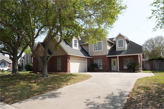 view of front facade with concrete driveway, an attached garage, fence, brick siding, and a front lawn