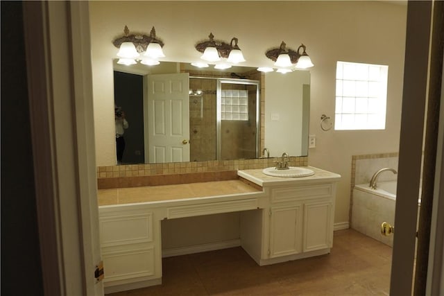 bathroom featuring vanity, a bath, and a shower stall
