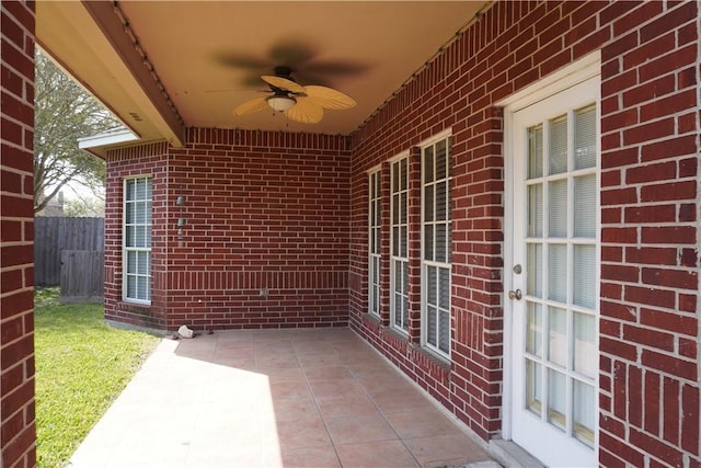 view of patio with fence and a ceiling fan